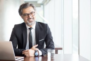 man smiling at a desk